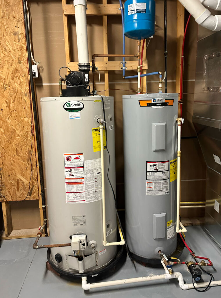 Two traditional tank water heaters before tankless water heater installation in Fishers Indiana